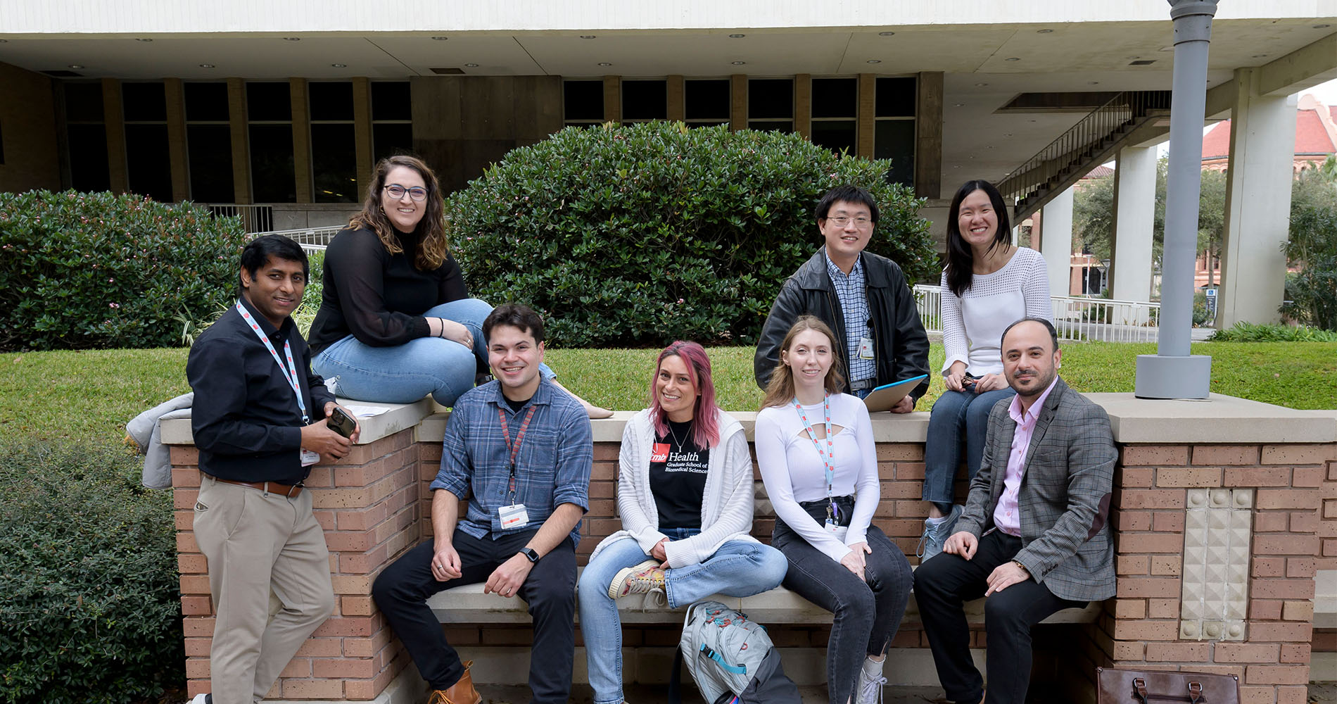 A diverse group of GSBS students sitting on a bench