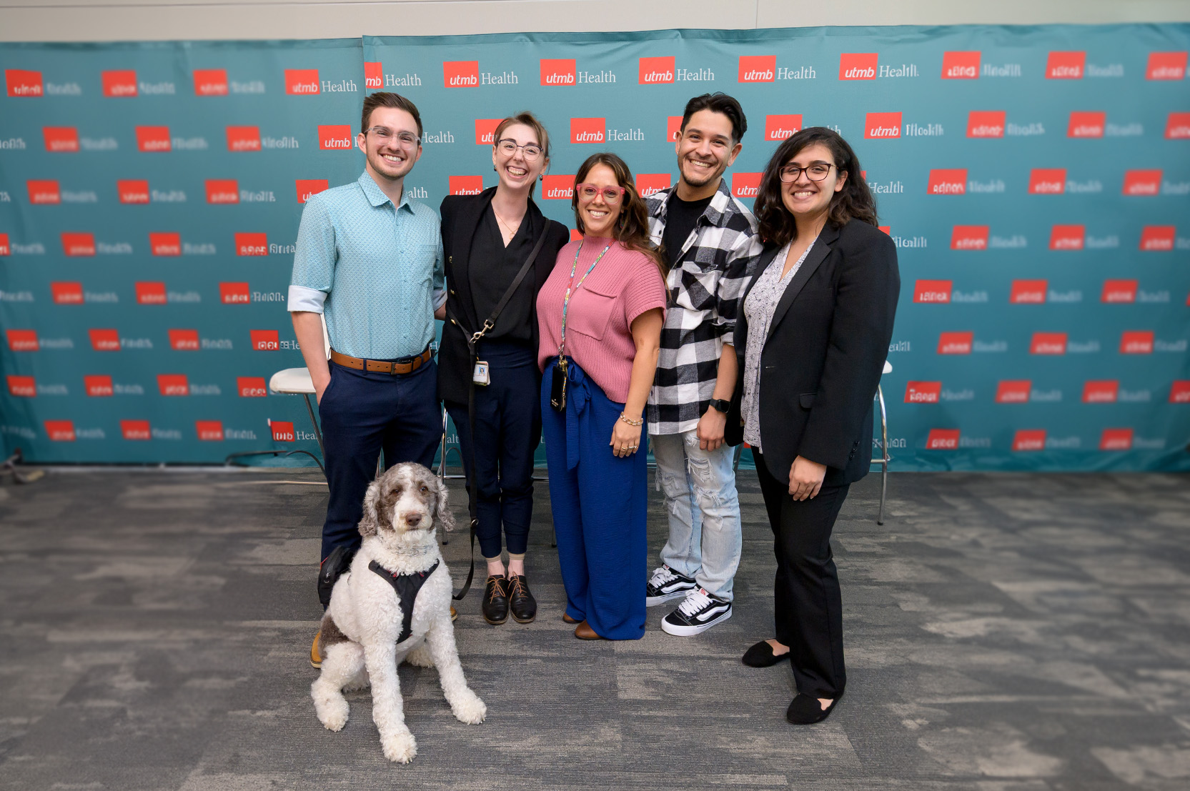 A group of GSBS students and a service dog posing for a photo