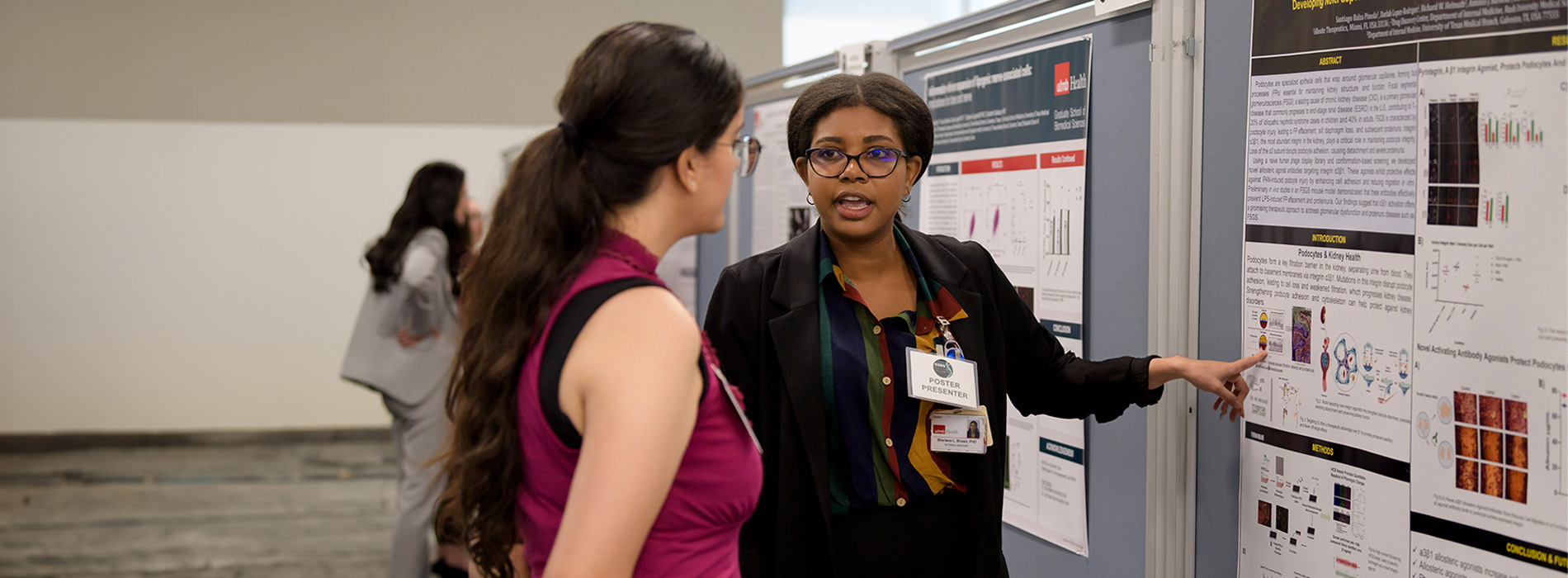 Two women looking at a display board in a conference
