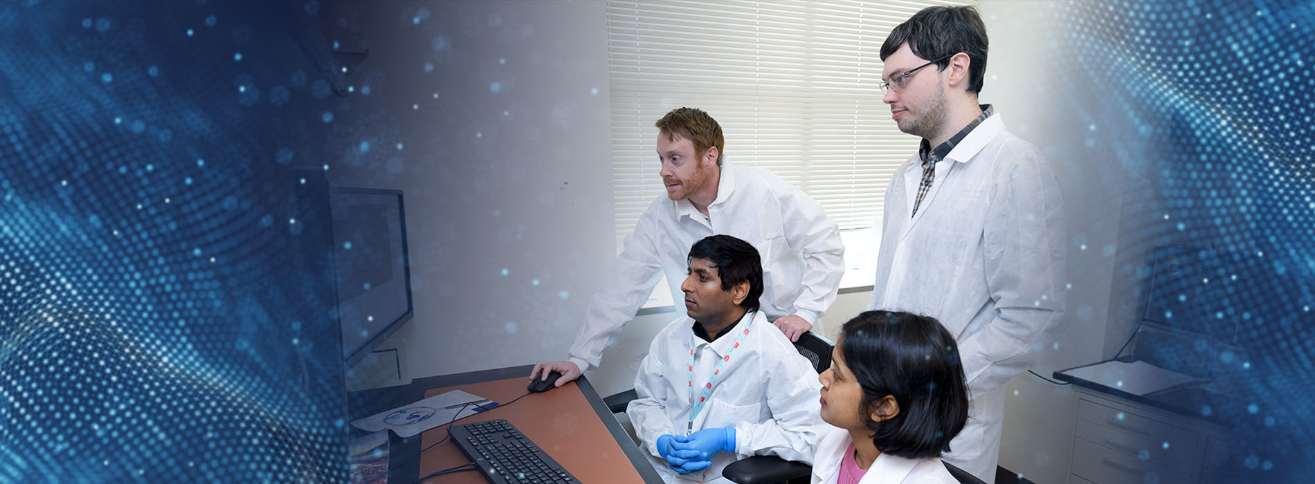 Four medical students gathered around a computer