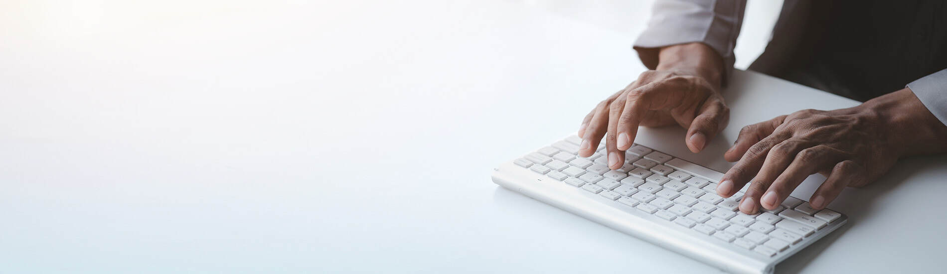 Close up of hands typing on a keyboard