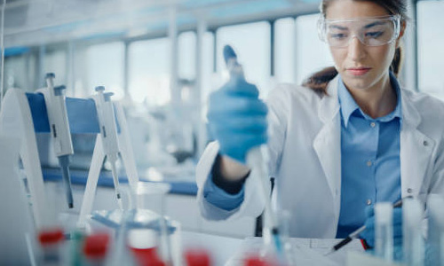 Woman pipetting a sample.