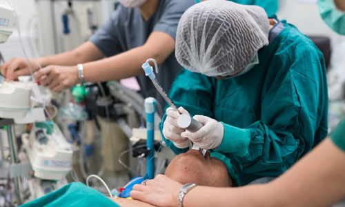 Photo of respiratory therapist intubating a patient.