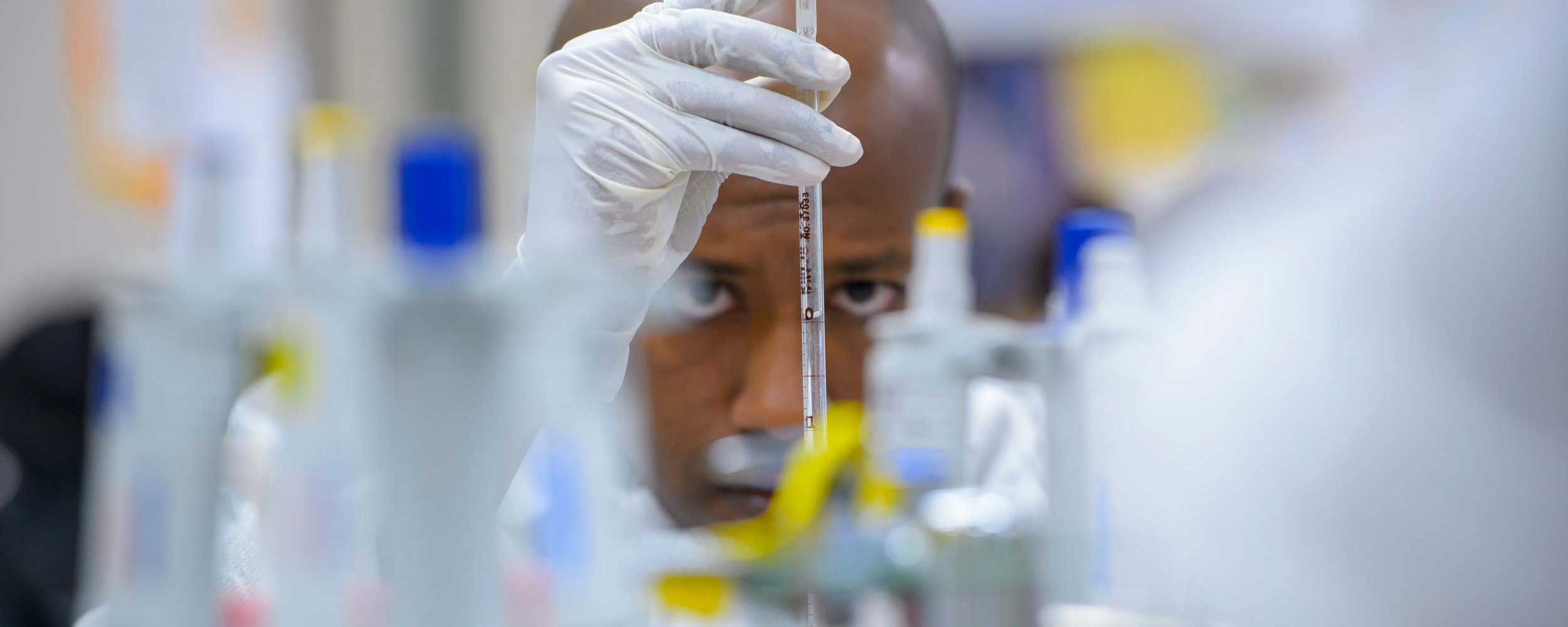 UTMB Researcher looking through equipment