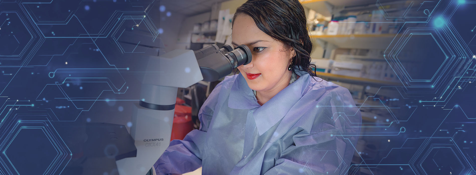 A researcher looking through a microscope
